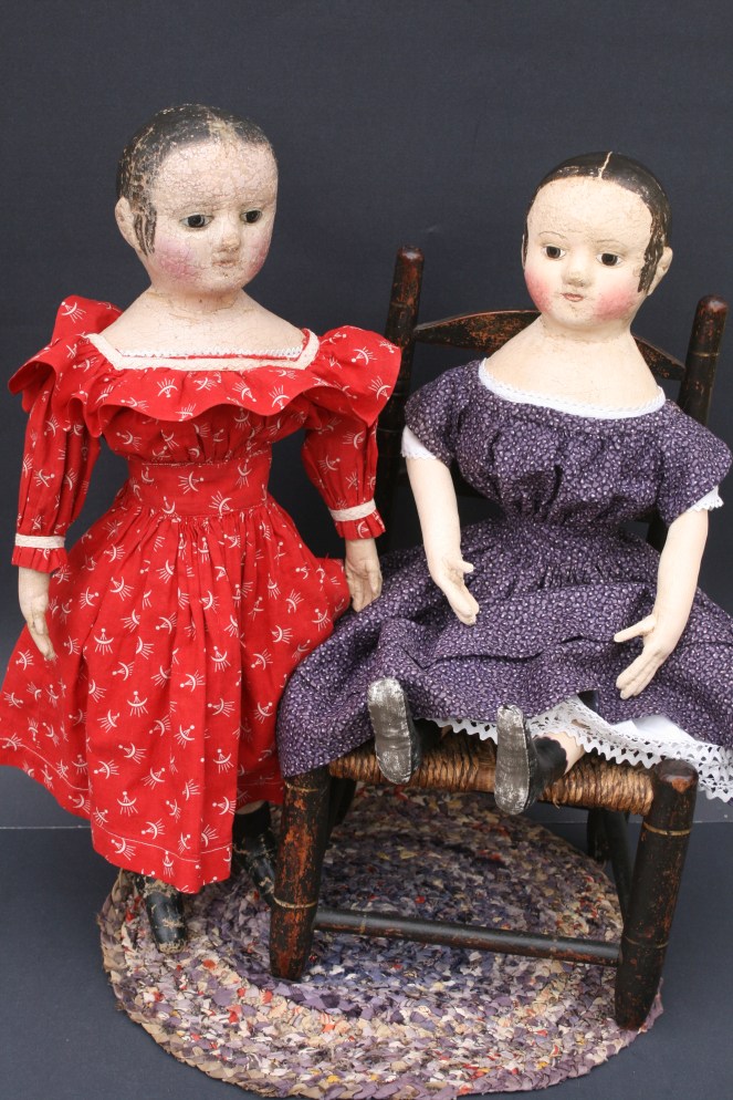 My c. 1860 antique Izannah Walker doll in red on the left and her newly made offspring c. 2013 dressed in dress made of rare "double violet" mid-19th century fabric.