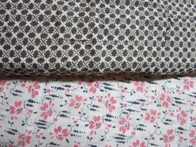 Two tattered and worn antique quilts that are stacked up in my studio waiting for me to take them apart and turn them into little Izannah dresses...