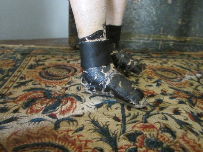 A side view of Izannah's painted boots.  Notice how the top of the boots are higher at the front of the leg and lower in the back.