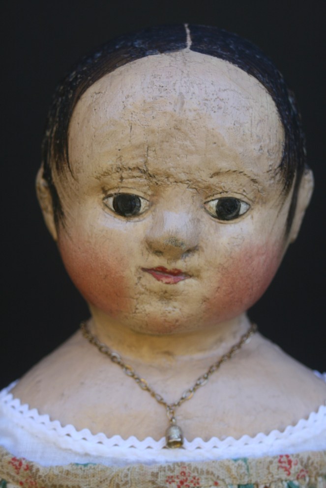 Anna#2 wears a tiny golden thimble on a chain around her neck.