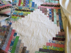 I quilted a vintage c.1960's log cabin quilt top that I have had waiting in my attic for several years.  Jan suggested a free form daisy quilting pattern, which was just perfect for the 60's :)
