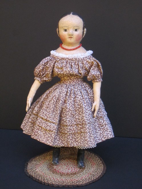 Isabeau #2 is wearing a dress that I made for her from a mid-1800's brown "coral" pattern print fabric.  The dress has full gathered sleeves, two growth tucks in the skirt and a deep 3 inch hem.