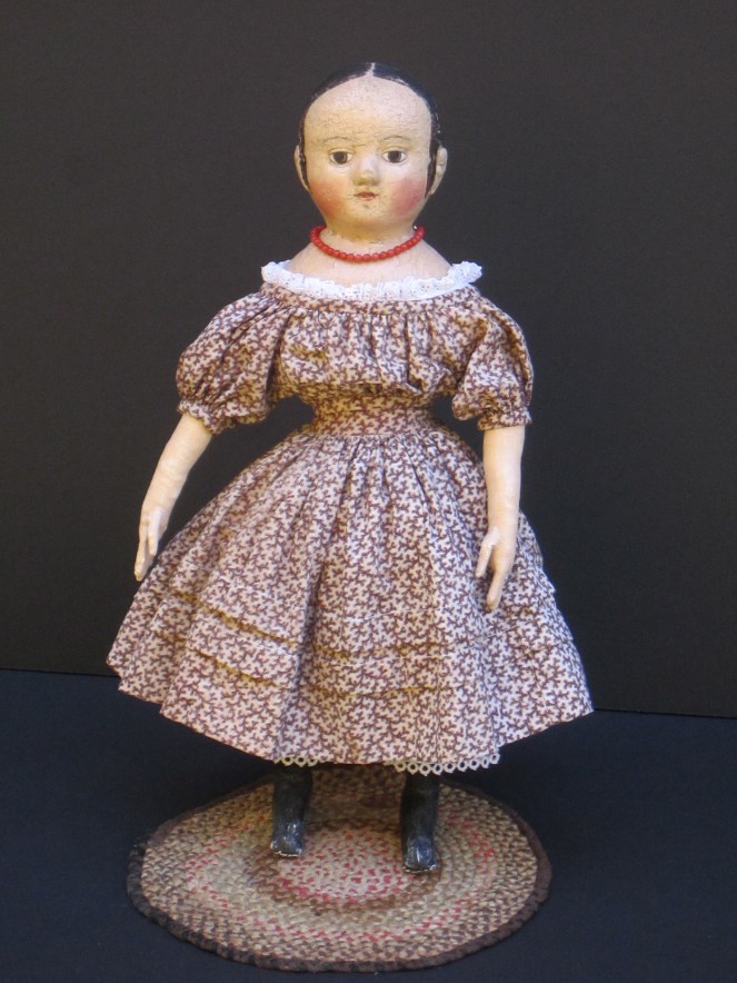 Isabeau #2 is wearing a dress that I made for her from a mid-1800's brown "coral" pattern print fabric. The dress has full gathered sleeves, two growth tucks in the skirt and a deep 3 inch hem.