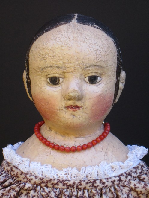 Isabeau #2 shows off her hand strung real coral beads.