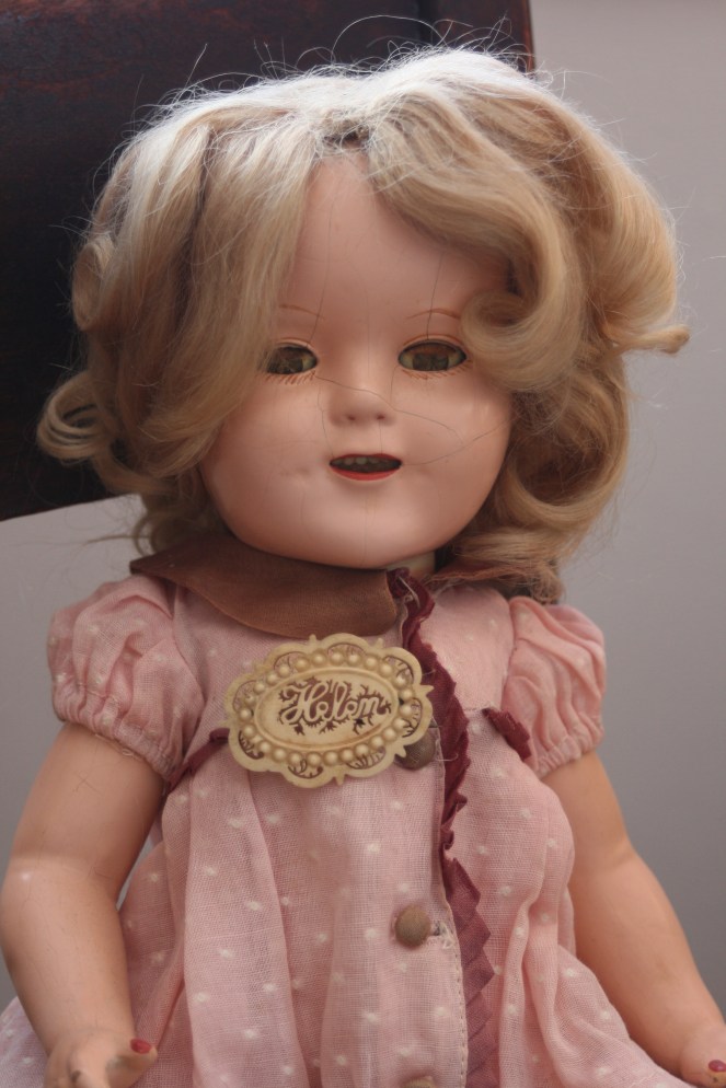 My mother's Shirley Temple doll is wearing a celluloid pin I bought because it reminds me of my mom.