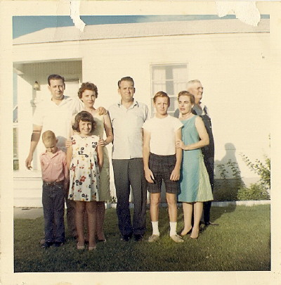 My mom is the one in the yellow dress.  I'm standing in front of her.  This was the only year in my whole life that I had short hair!