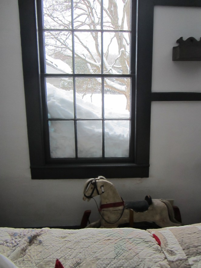 The foot of new fallen snow, on top of the snow from the last storm, obscures some of our second floor windows.