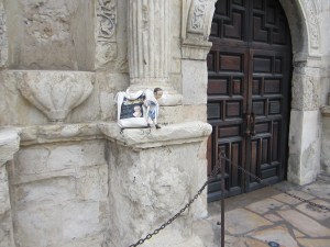 Izzybelle posing by the doors of the church at the Alamo.