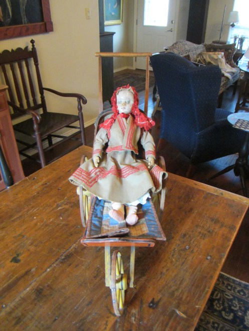 Ismay loved trying out this early doll carriage.  She said it was very comfortable and just her size!