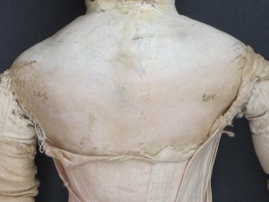 Fortunately the doll's original paint color was visible on a protected area of her back. 