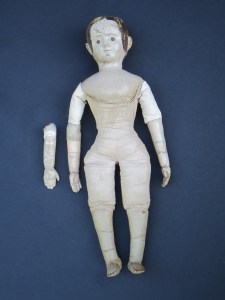 After restoration.  The change in color is very subtle.  These photos were taken before the doll was seen by her owner.  After the owner had a chance to see the replaced arm and replaced antique linen upper arm covering, we decided to "age" the fabric and arm more.  The upper arm above the replacement is too fragile to clean, which left the dilemma of what color to paint the replaced lower arm... Should it match the other cleaned arm? Or should it match the uncleanable upper arm fragment it is attached too???