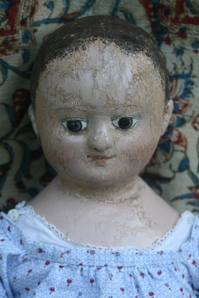 This is what she looks like after I removed four layers of repaint and did a very small amount of judicious in painting.  As you can see much of her original paint had been worn away, so it is very easy to understand why she received  new coats of paint. 