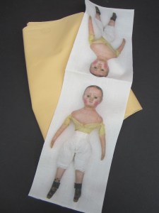 Make two dolls with each panel by adding your own plain fabric on the back.