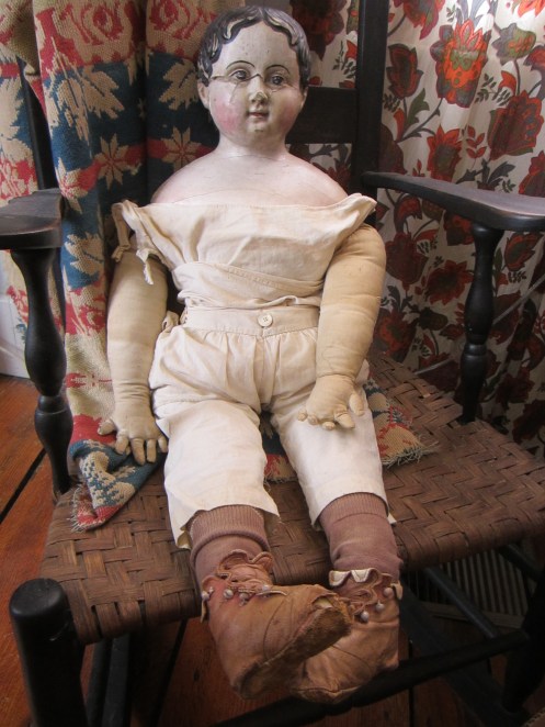This very large papier-mache doll can wear children's size clothing.