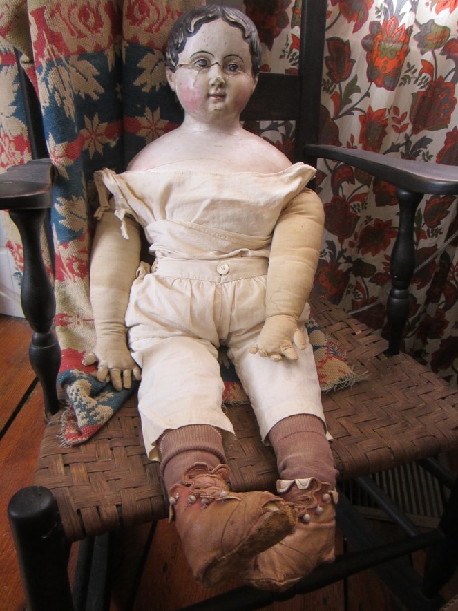 This very large papier-mache doll can wear children's size clothing.