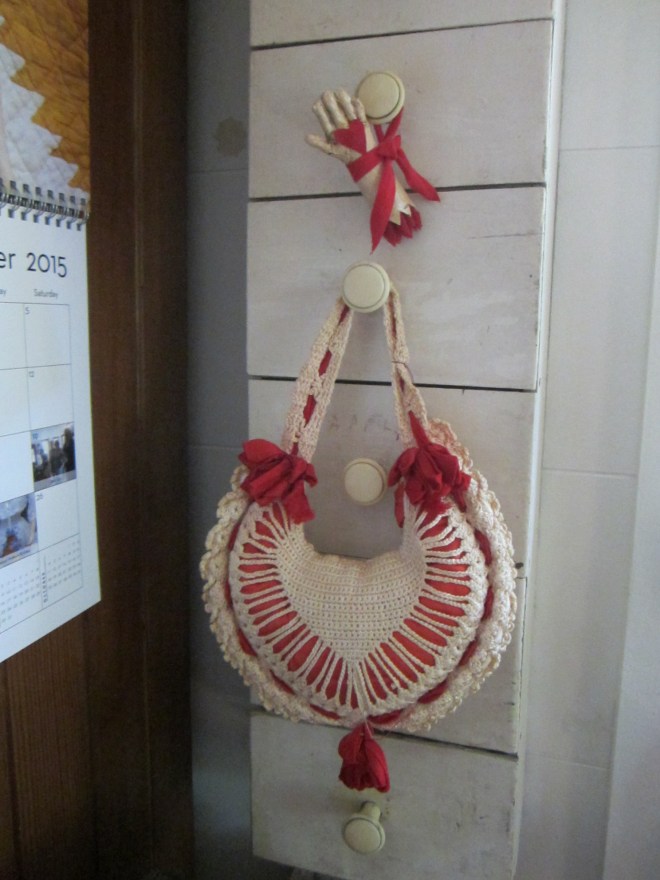 This is how I have the tiny hand displayed in my studio. The little white drawers are filled with buttons.